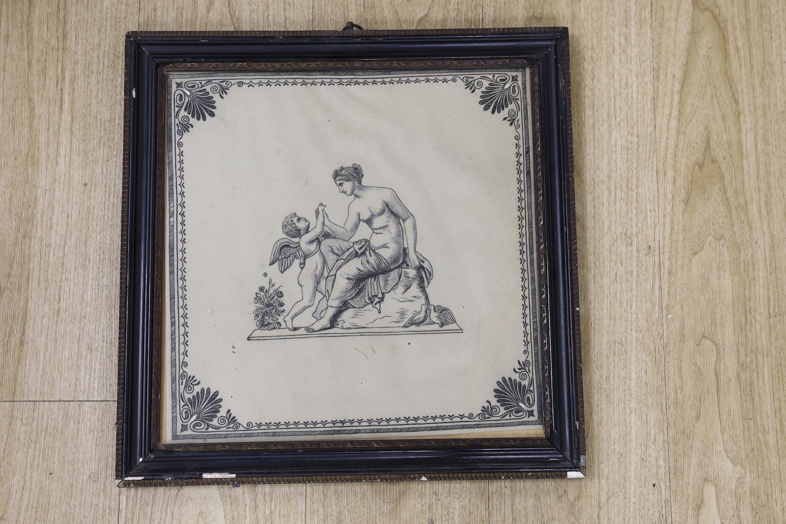 A framed Regency felt monochrome embroidered panel of a seated classical figure with cherub and doves, 36cms x 36cms